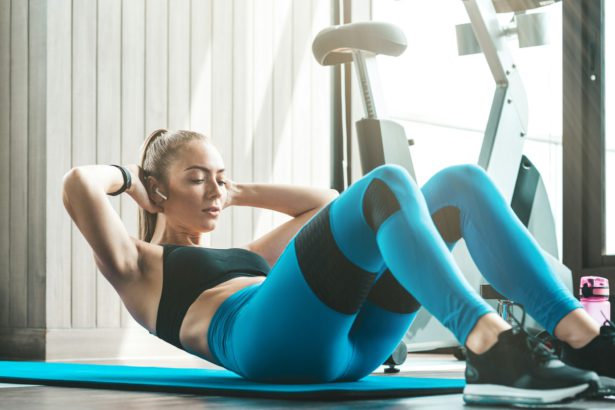 Better. Faster. Stronger. Fitness girl doing crunches indoors