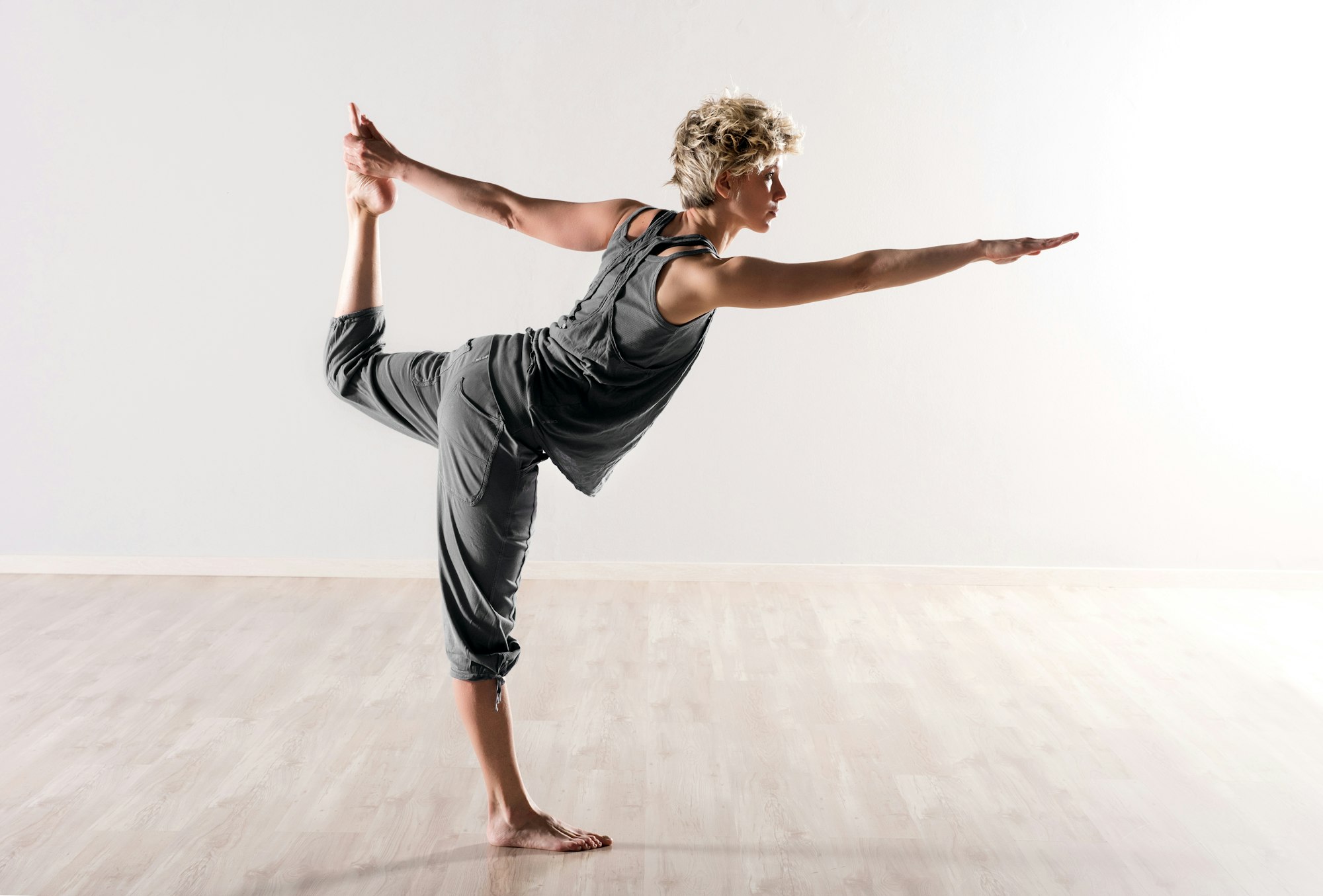 Young woman doing yoga balancing exercises